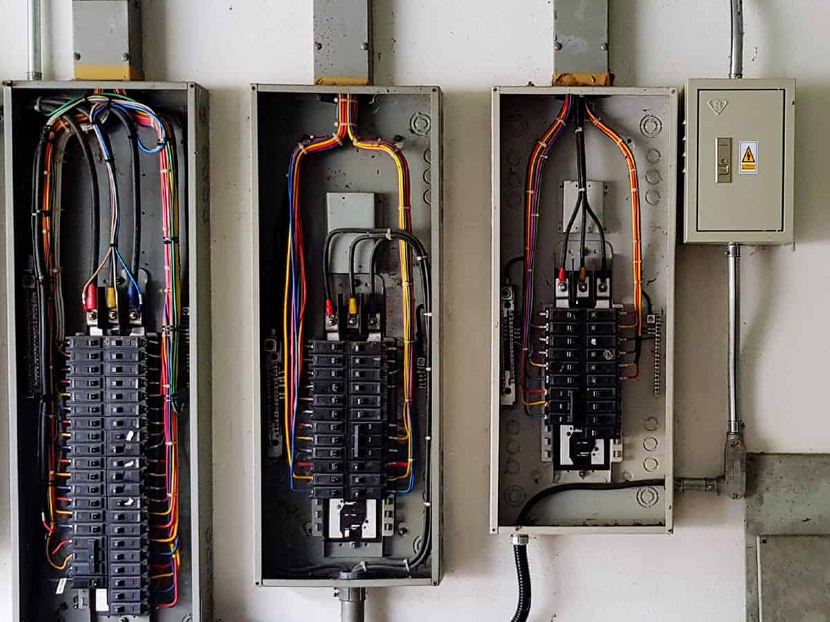 Circuit breaker panels open in garage-like setting