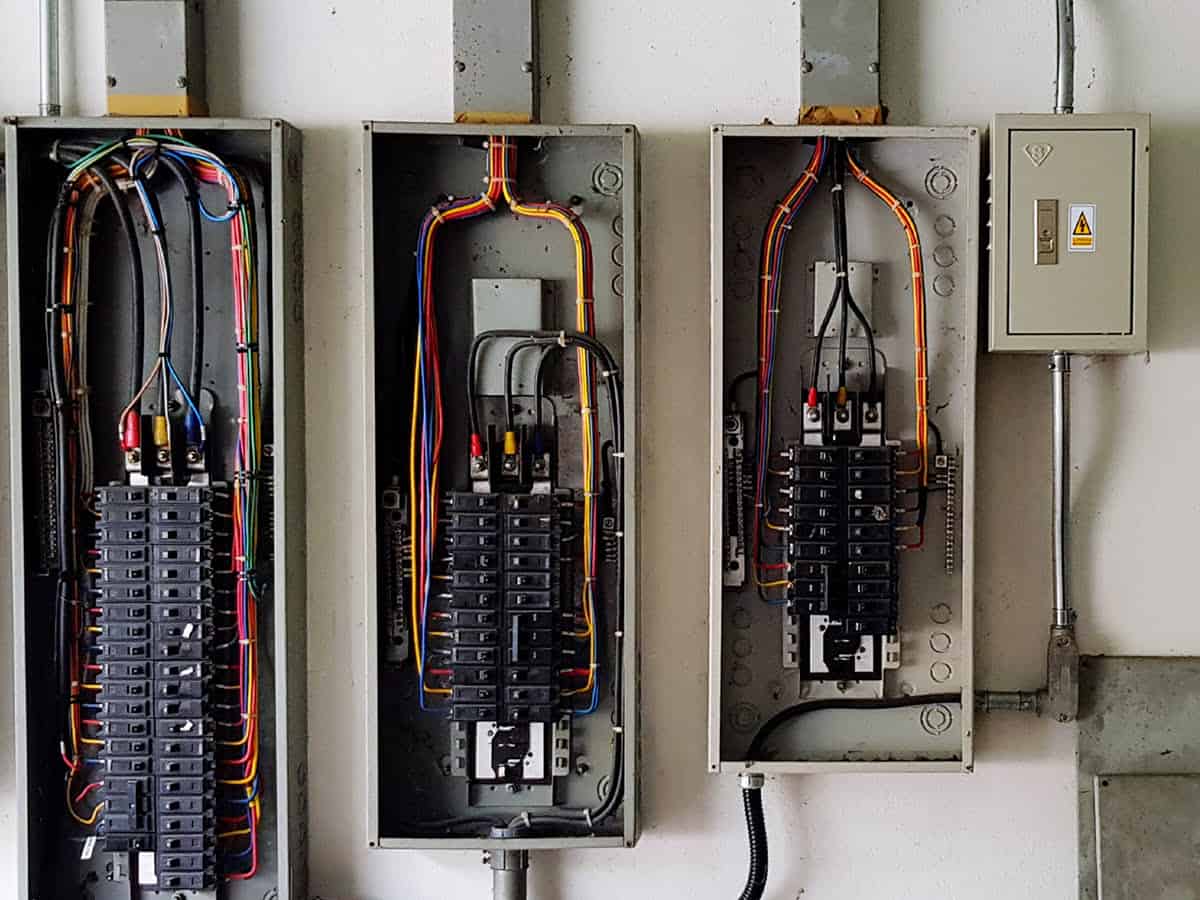 Circuit breaker panels open in garage-like setting Circuit breaker panels open in garage-like setting