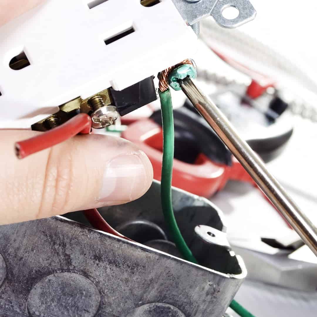 picture of electrician fixing outlet